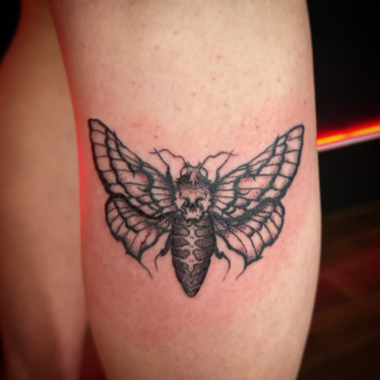 Picture of a death's-head hawkmoth leg tattoo.