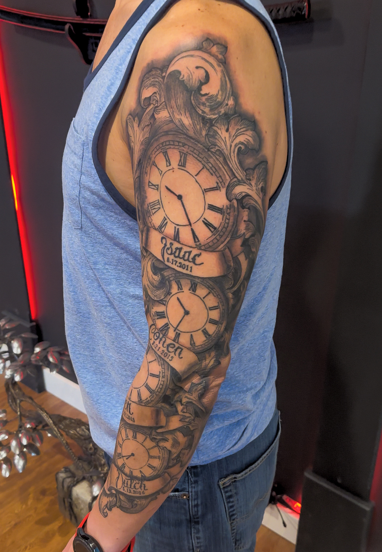 Picture of a mixed style realism and traditional clock sleeve tattoo.