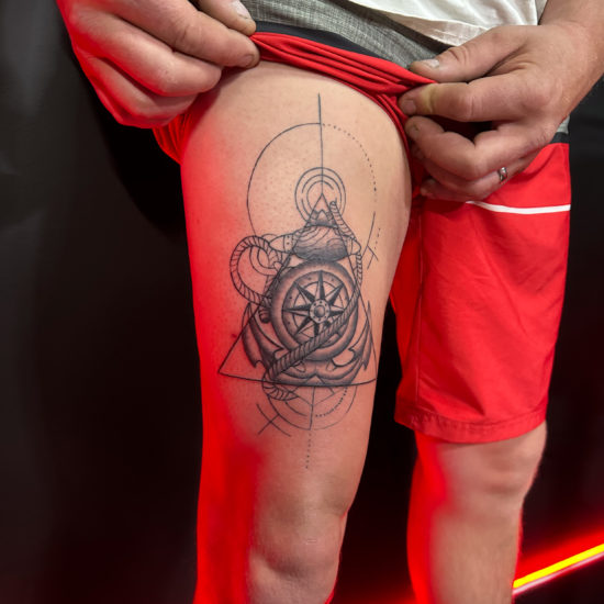 Picture of a mixed style traditional and geometric anchor tattoo.
