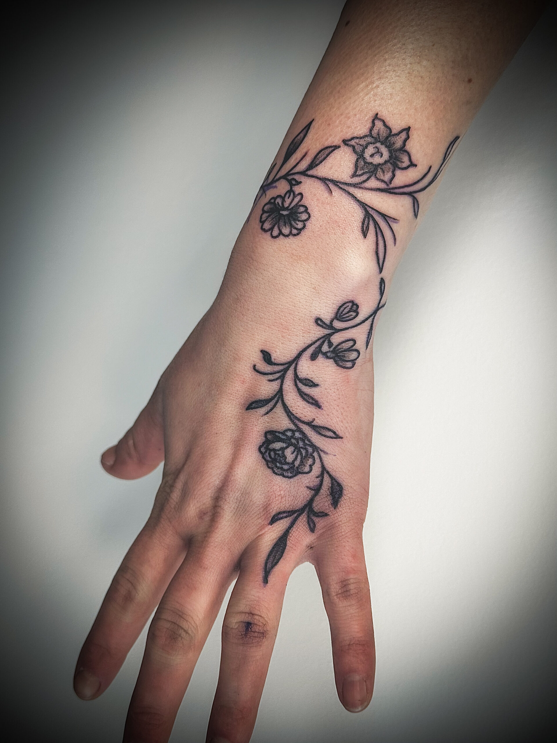 Hand linework vine tattoo